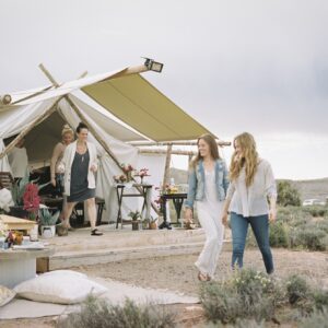 group-of-friends-enjoying-an-outdoor-meal-a-tent-in-the-background-.jpg